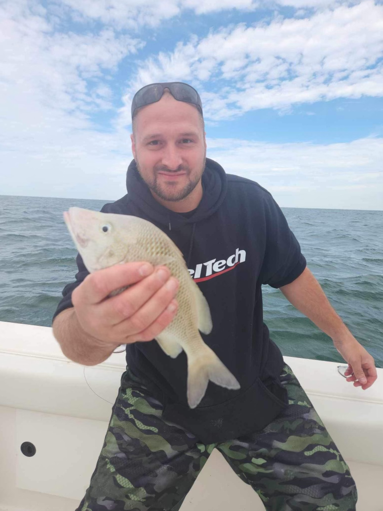 Man holding fish on Thermocline Charters Boat